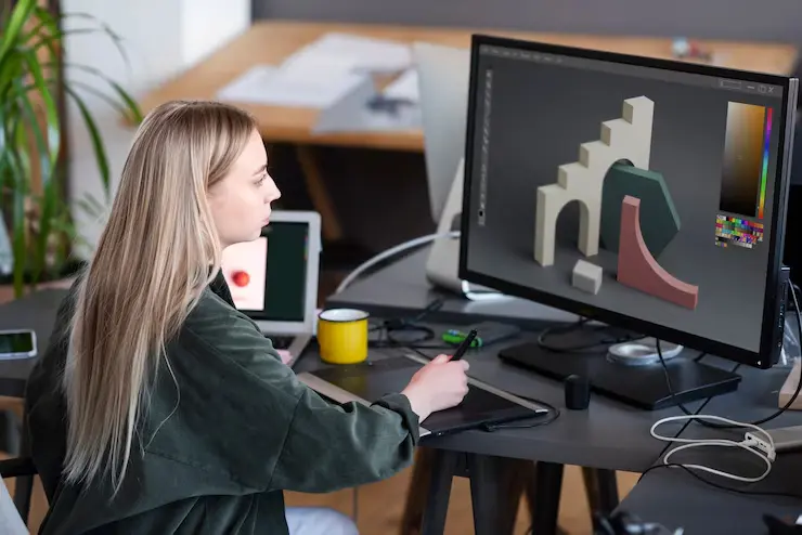 Unity Game Development Agency in Canada Young woman working on game animation in a studio environment.