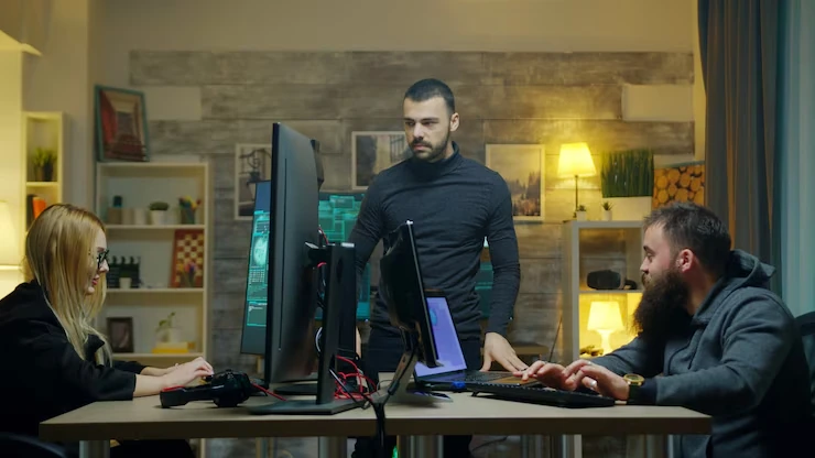 Console Game Development Agency in Canada team collaborating on game coding